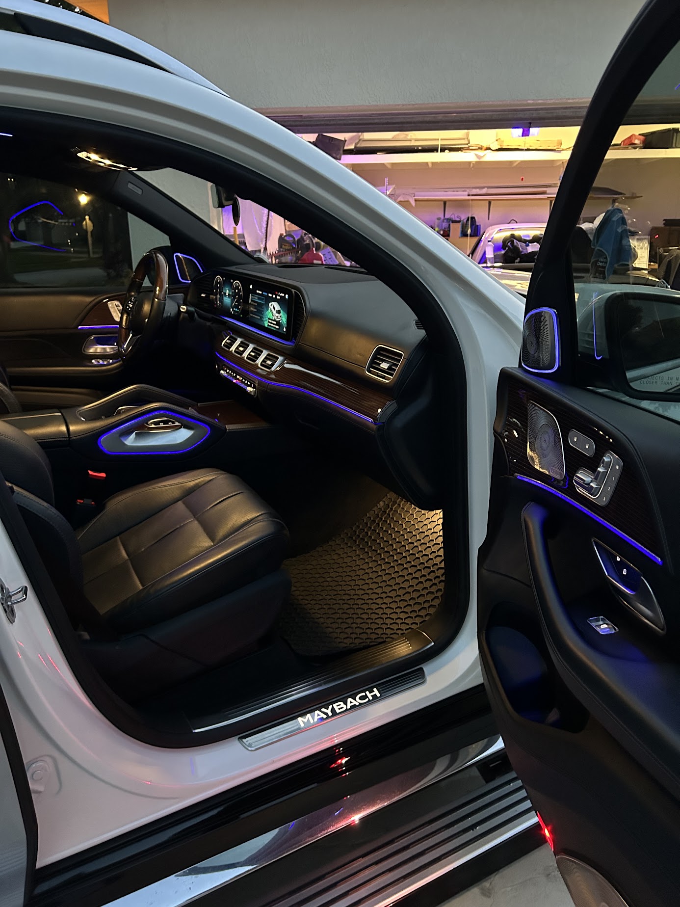 Cleaned leather seats, wood trim and detailed door panel inside a white Mercedes-Maybach GLS SUV