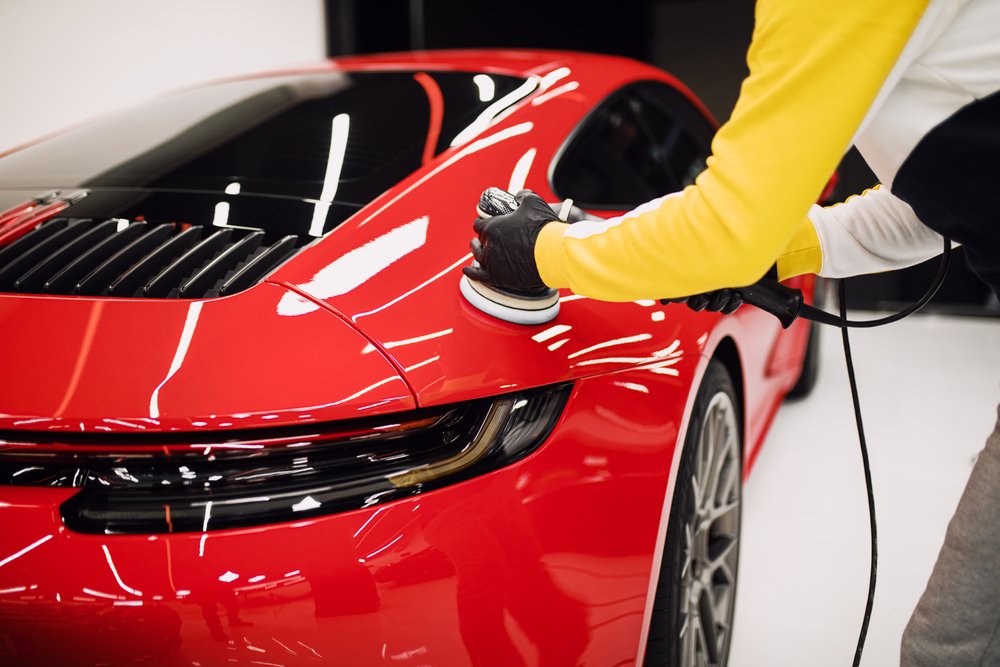 Polishing a red sports car